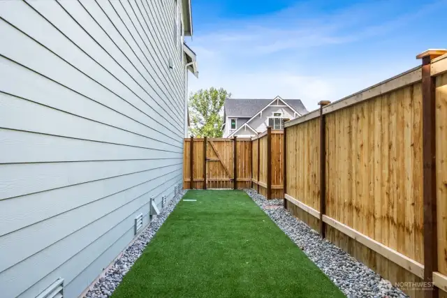 Private, low maintenance yard with artificial grass on one side. You won't be tied to a ton of yard work here, free to spend your time on what you love to do!