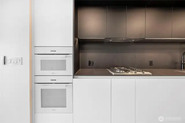 Custom B&B Italia cabinetry. Gas range. Do not miss the motorized blinds remote controller.