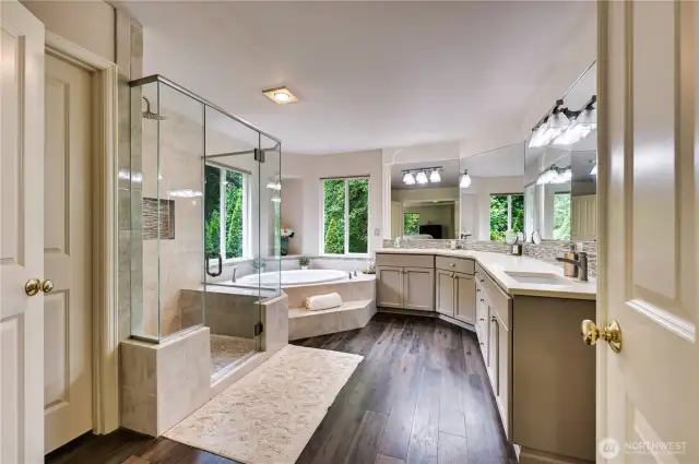 Double doors open to the spa inspired beautifully updated bath