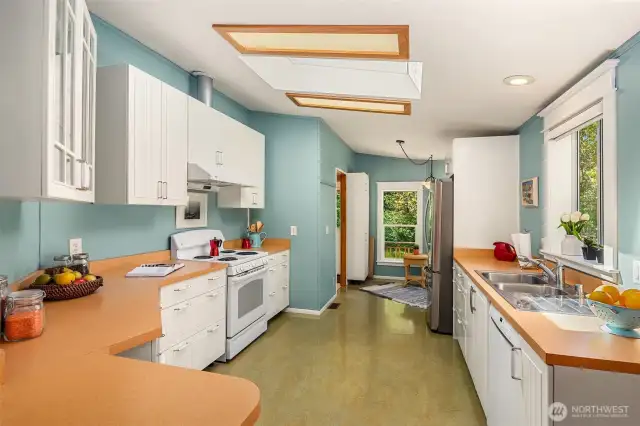 Kitchen is spacious and well-laid out. Tons of cabinet and counter space.