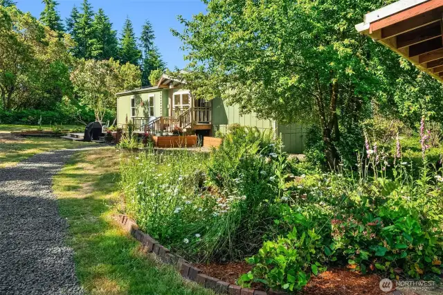 Nicely manicured beds and freshly graveled drive.