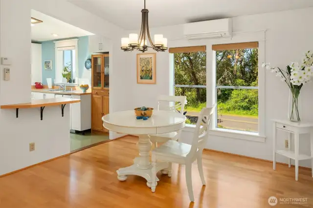 Sweet dining nook has huge windows to bring the outside in.
