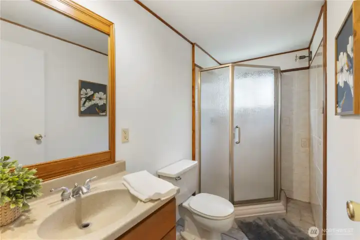 Updated vanity and tile flooring in the three quarter bathroom.