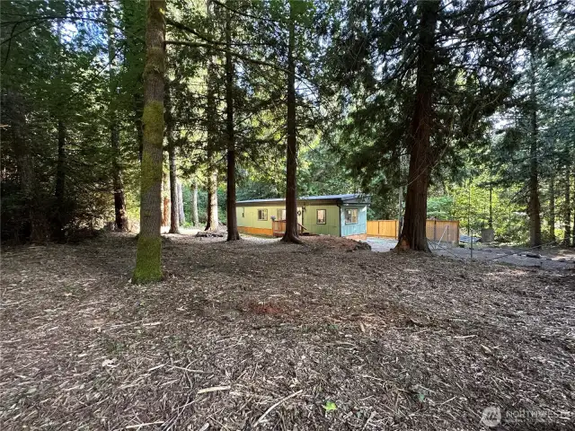 Huge front yard, remove some trees and add a culvert and there's room for a garage.