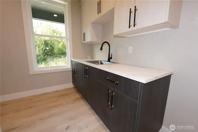 The laundry has a large counter and lots of cabinets