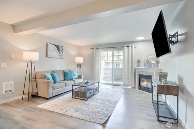 Basking in natural light, this radiant living room is sure to lift your spirits as you unwind on the cozy couch and enjoy the warm glow of the gas fireplace.