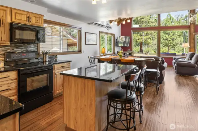 The recently updated kitchen features striking Black Galaxy granite countertops paired with rich hickory cabinets—blending style, warmth, and durability.
