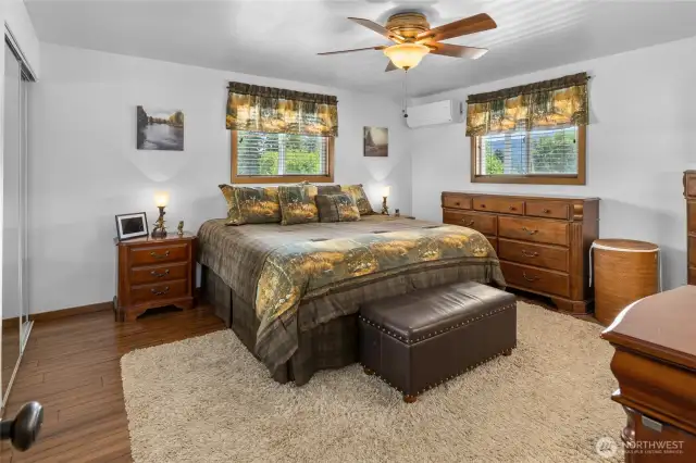 A spacious main-floor bedroom currently serves as the primary suite, though the upper-level bedroom offers another great option for those seeking a connected bathroom and elevated views.