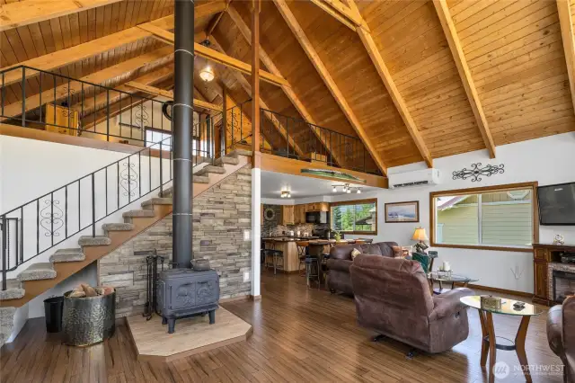 Classic chalet style floorplan features a Cawley 800 wood burning stove with triple lined chimney as the cozy centerpiece of home. In 2024, a new Bosch mini split heat pump was installed in 2024 offering both primary heating and cooling.