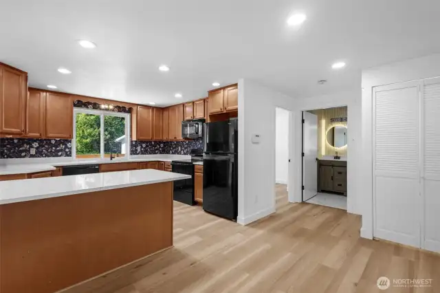 Beautifully remodeled kitchen with quartz counters and center island.