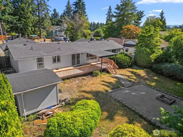 Spacious concrete patio with built-in fire pit for cozy evenings.