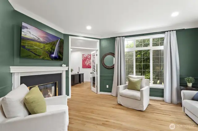 Formal living room with a gas fireplace and elegant wainscoting.
