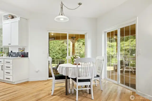 Informal dining area with 2 sliding glass doors to the covered deck and backyard.