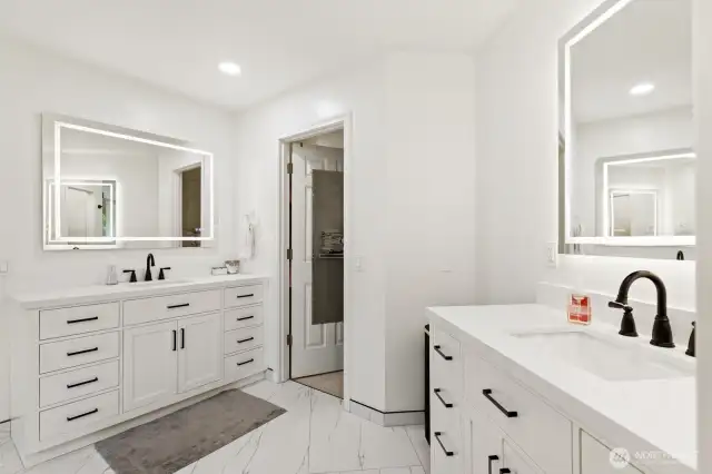 Dual quartz vanities with back lit LED mirrors.