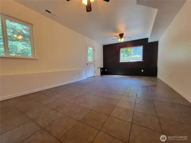 Lower level family room with door to backyard.