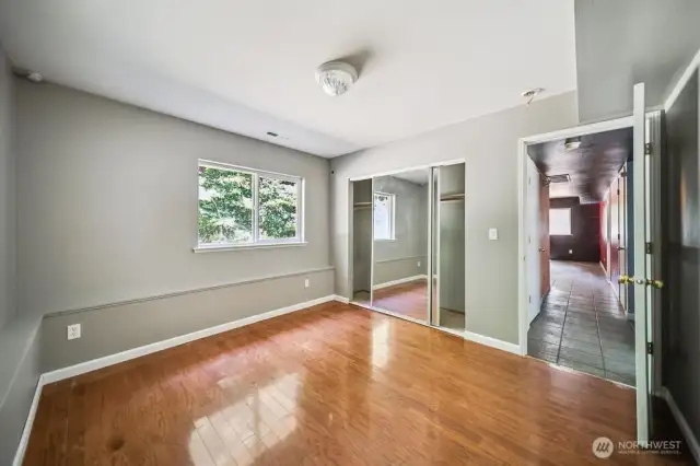 Lower level bedroom. Family room in background is now painted white.