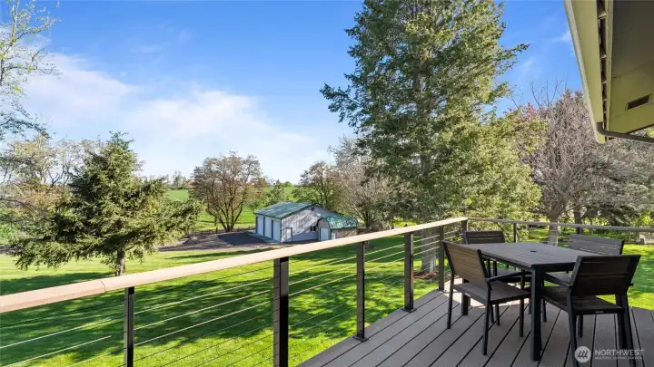 This lovely front deck, just off the kitchen, is plumbed for a grill and is such a wonderful place from which to take in sunsets and the beauty of the property.