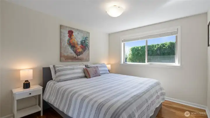 The second upstairs bedroom (shown here with a king bed) is adjacent to the full hall bath with soaking tub.