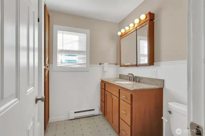 Full bath with vanity storage.
