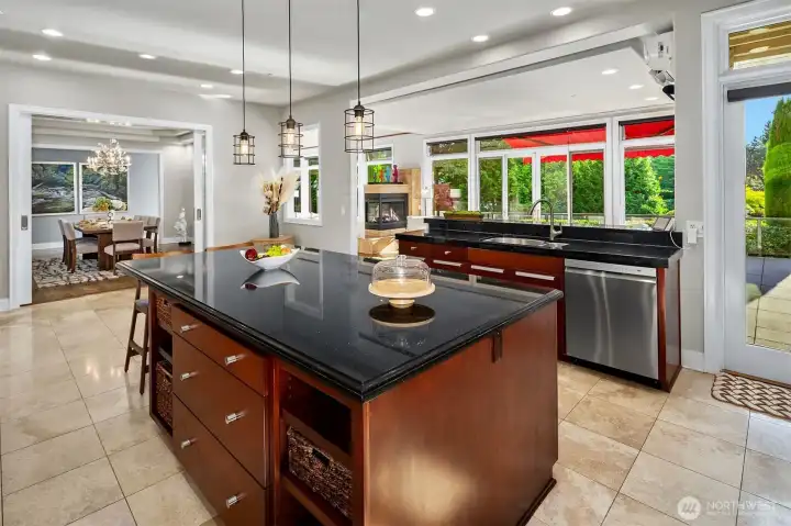 The Kitchen is the heart of the home and open to the formal dining room, informal dining room, living room, and a door straight out to the deck