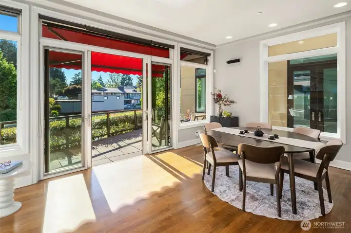 Informal dining room opens to deck overlooking the canal. It could also be used as a second living room