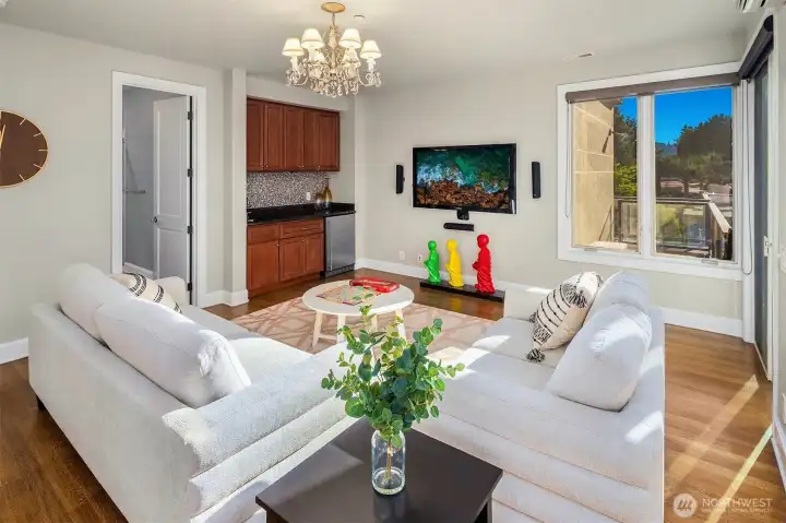 Second floor large flex space has a wet bar and opens to the roof rooftop deck