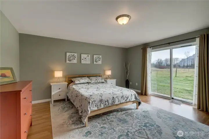 Primary bedroom with sliding doors to access small deck - 2 steps to the yard.