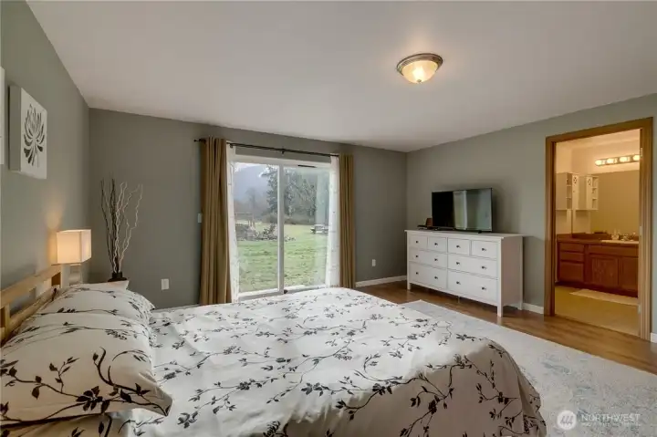 Photo of primary bedroom looking toward ensuite bathroom.