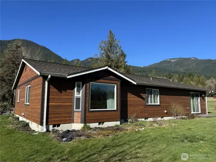 Photo showing living room bay window area.  Sellers had planned to install doors here, and build a deck accessed from that point.