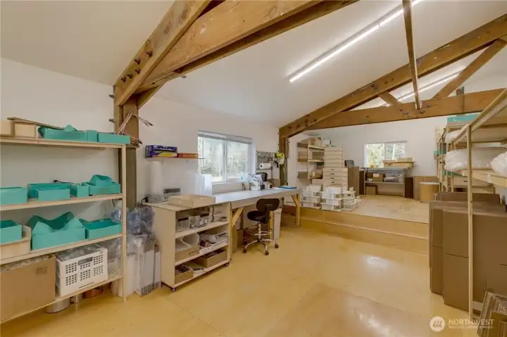 Third view of loft. Elevated floor at back of area accommodates high entry door to shop space below.