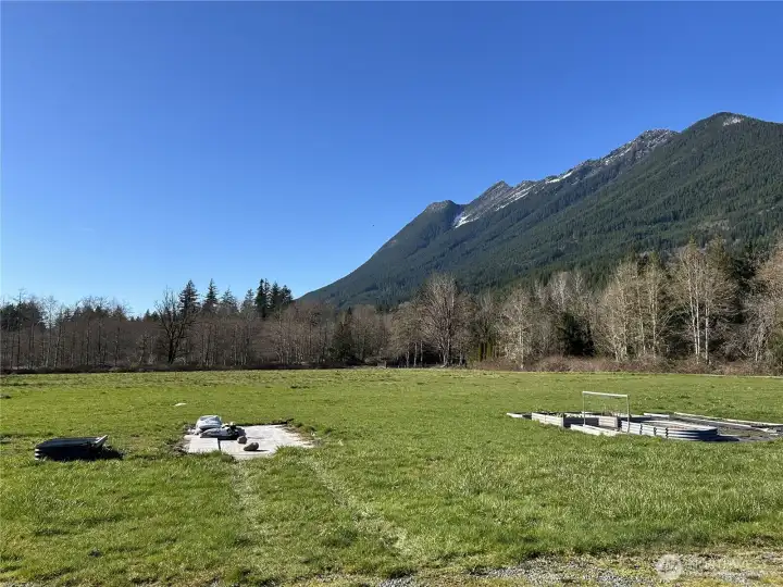 Looking across the cleared and level property, towards 371st Ave NE (private road) at the treeline.