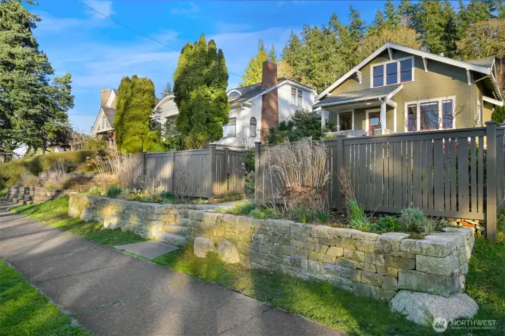 The dry stack retaining wall, steps, hardscape and raised beds are all new along with the elegant fencing