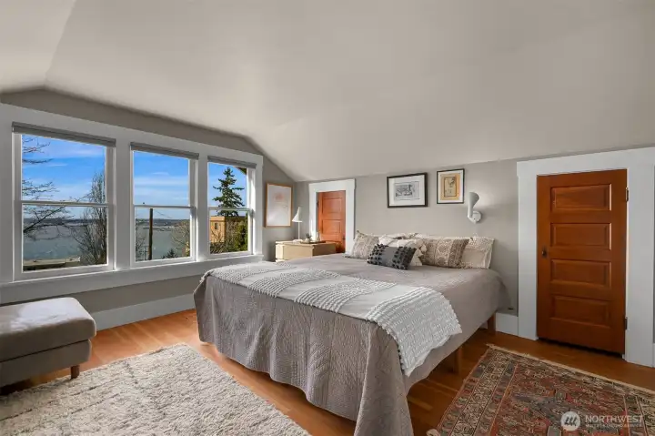 The primary suite is a dreamy space with views of the bay, a corner fireplace and room for a seating area as well