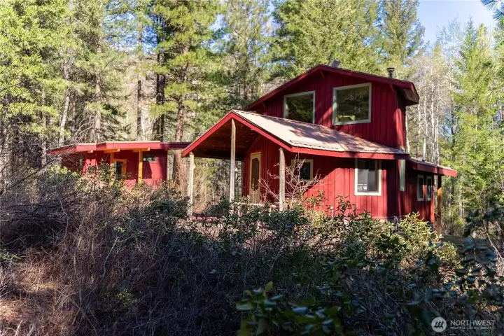 The 20-acre riverside property has both a cabin and guest studio.