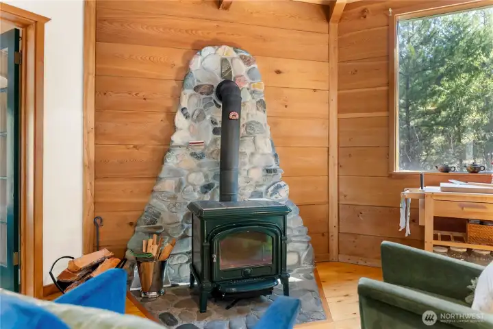The cast iron wood stove has a custom river rock hearth.