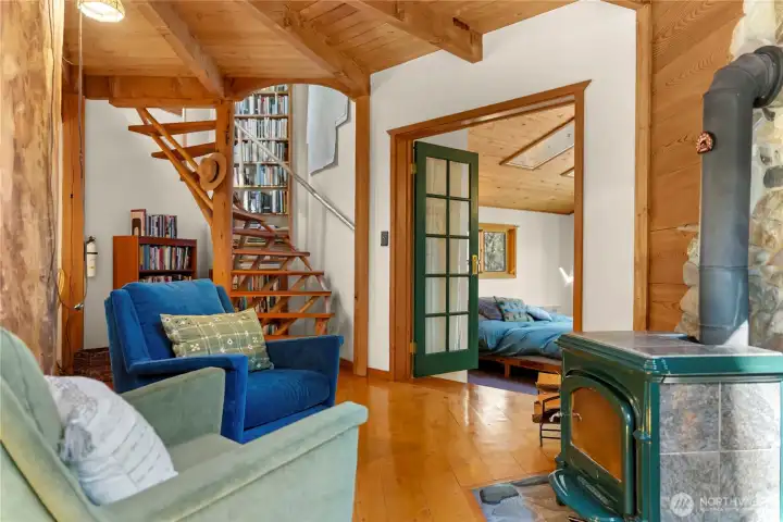 The cabin's living space opens to primary bedroom and bath, and 2nd story.