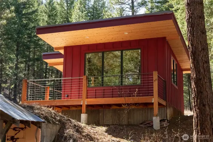 It is perched on the edge of a slight rise to maximize a view of the riverfront forest.