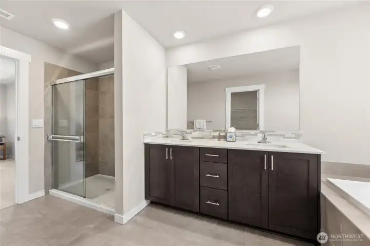 Stand-alone shower and double vanity. Home is staged.