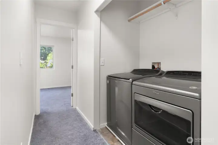 Hallway laundry with clothes rack. Bi-fold doors are stored in the garage if you would like to install them.