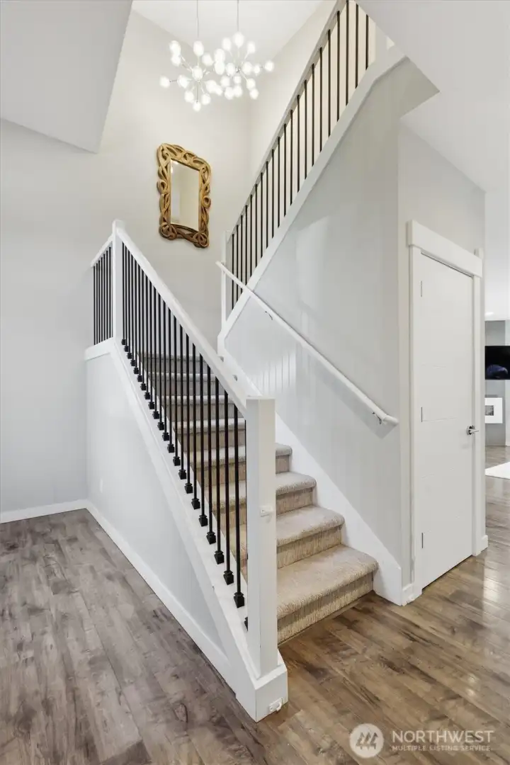 The staircase keeps the entry feeling bright and connected without closing off the space. The staircase keeps the entry feeling bright and connected without closing off the space.