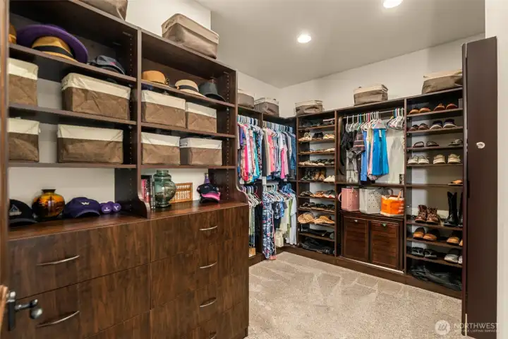 Large walk-in closet with built in drawers and shoe racks.