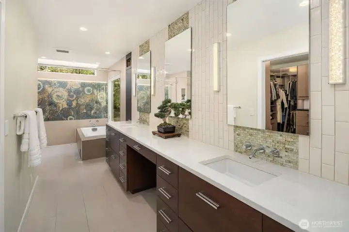 Breathtaking primary bath with an oversized shower with custom tile, soaking tub + lengthy vanity