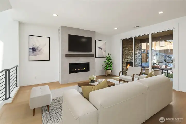 Great room with fireplace opens to covered patio