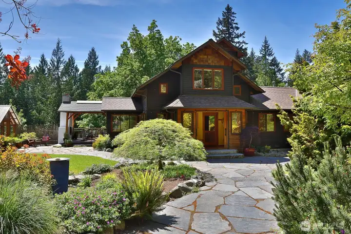 View as your are entering from the driveway/carport. You have just stepped through the gate of the fenced portion of the land onto an expansive Flagstone pathway. Exterior of the home is cedar siding & cedar shingles. View as your are entering from the driveway/carport. You have just stepped through the gate of the fenced portion of the land onto an expansive Flagstone pathway. Exterior of the home is cedar siding & cedar shingles.