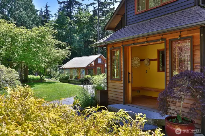 Handcrafted cedar and fir sliding glass doors open to a spacious entryway with a live edge cedar bench, fir floors and cedar planked ceiling. Let's go inside and see how the beauty of nature is woven within and throughout this home. Handcrafted cedar and fir sliding glass doors open to a spacious entryway with a live edge cedar bench, fir floors and cedar planked ceiling. Let's go inside and see how the beauty of nature is woven within and throughout this home.