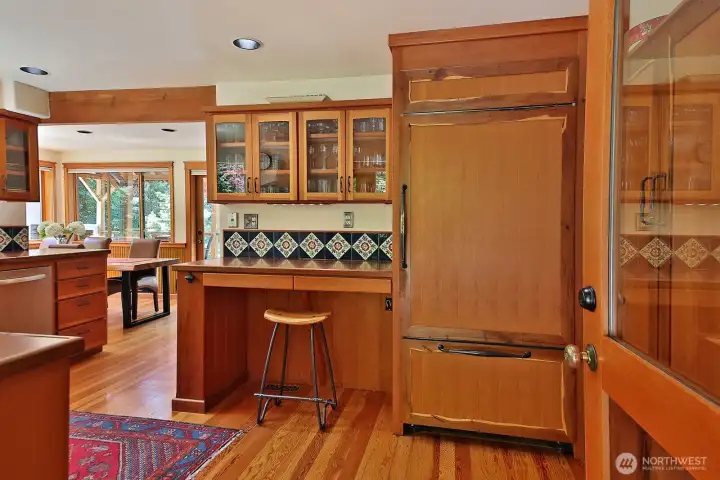 View as you step from the entry way into the kitchen. Custom Fir cabinetry with Fir and Yew panels on the fridge and pantry (pantry cabinets are alongside the right edge of this photo, glimpse through the glass of the door.) Dining area glimpsed along the left edge of the photo. View as you step from the entry way into the kitchen. Custom Fir cabinetry with Fir and Yew panels on the fridge and pantry (pantry cabinets are alongside the right edge of this photo, glimpse through the glass of the door.) Dining area glimpsed along the left edge of the photo.
