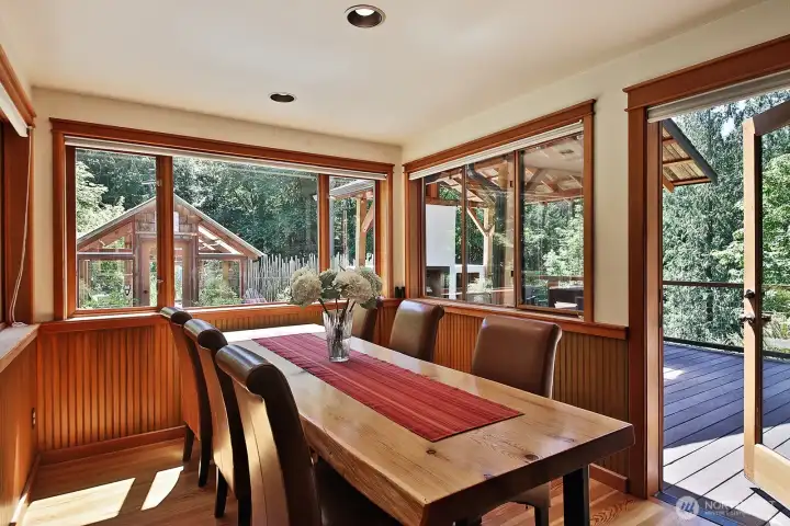 Dining area connects the Kitchen to the Living Room and to the deck with the Cabana with an outdoor fireplace. Deck wraps around entire west side of home and to lower level Workshop & Studio/Flex space. The bell on the deck walkway does not convey. Dining area connects the Kitchen to the Living Room and to the deck with the Cabana with an outdoor fireplace. Deck wraps around entire west side of home and to lower level Workshop & Studio/Flex space. The bell on the deck walkway does not convey.