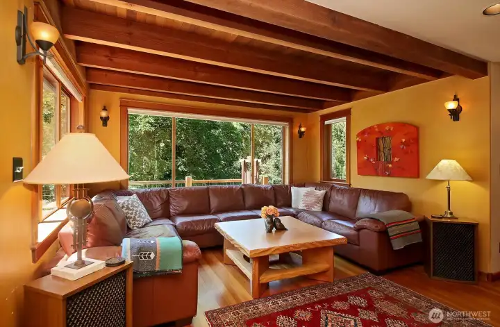 Fir floors & Cedar tongue and groove ceilings provide an inviting sense of warmth. Generous windows keep you present with nature. Hallway to Primary Suite, Family Room & Office is beyond the right edge of photo. Main level 3/4 bath and stairs to 2 Bedrooms, Half Bath, and Tower is also beyond the right edge of photo. Fir floors & Cedar tongue and groove ceilings provide an inviting sense of warmth. Generous windows keep you present with nature. Hallway to Primary Suite, Family Room & Office is beyond the right edge of photo. Main level 3/4 bath and stairs to 2 Bedrooms, Half Bath, and Tower is also beyond the right edge of photo.