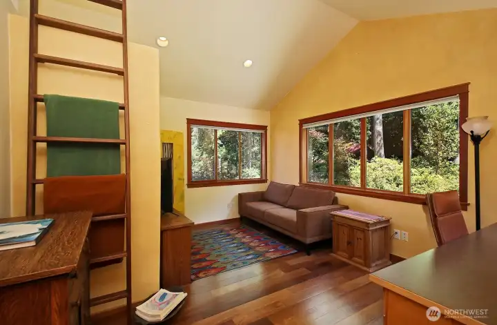 Family Room that also lives as an office. Loft storage (or reading nook for the young) up the ladder along the left edge of photo. This is the Northeast part of the home. Family Room that also lives as an office. Loft storage (or reading nook for the young) up the ladder along the left edge of photo. This is the Northeast part of the home.