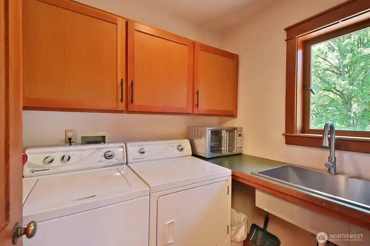 Located across from the Primary Suite with a utility sink. Just outside the Laundry room is a door to the wrap around deck with an outdoor shower. Let's go upstairs.... Located across from the Primary Suite with a utility sink. Just outside the Laundry room is a door to the wrap around deck with an outdoor shower. Let's go upstairs....